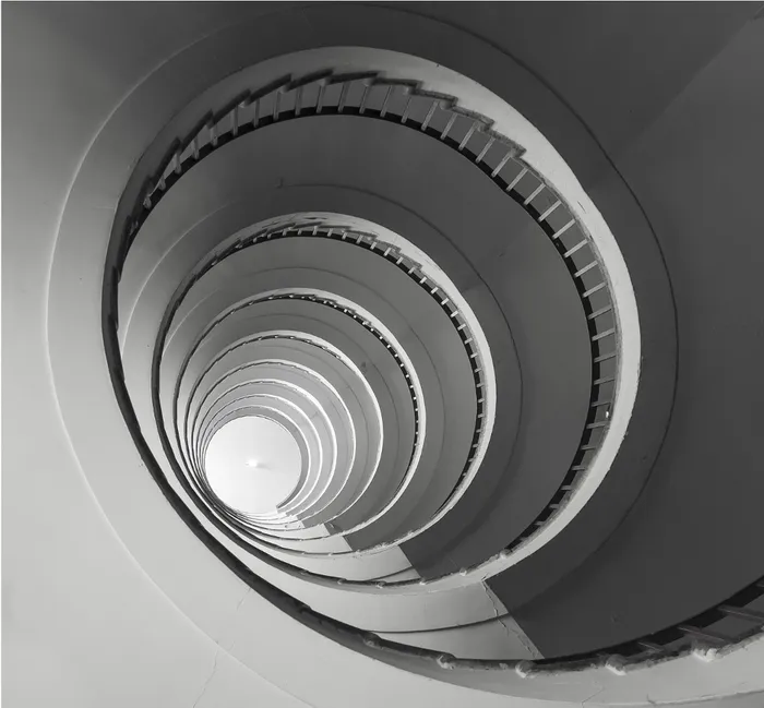 A spiral staircase viewed from the bottom looking up