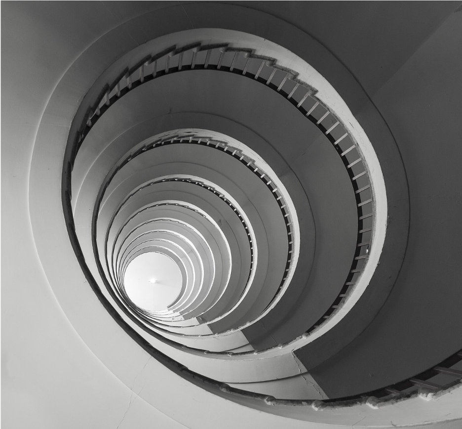 A spiral staircase viewed from the bottom looking up